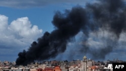 Smoke rises from the center of Sirte amid heavy fighting in the coastal city.