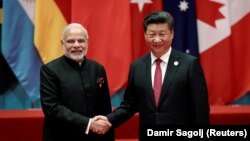 FILE: Chinese President Xi Jinping (R) shakes hands with Indian Prime Minister Narendra Modi during the G20 Summit in Hangzhou in September 2016.