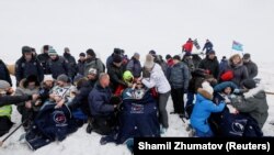 ISS crew members Serena Aunon-Chancellor of the United States, Alexander Gerst of Germany, and Sergei Prokopyev of Russia rest after the landing of the Soyuz MS-09 capsule in a remote area of Kazakhstan on December 20.