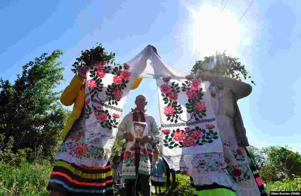 Local women wearing traditional costumes perform a dance in the Belarusian village of Pogost. On May 6, Belarus celebrated a spring harvest feast, a tradition that dates back centuries. (TASS/Viktor Drachev)