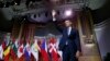 U.S. President Barack Obama waves after delivering a speech at Palais des Beaux-Arts in Brussels on March 26.