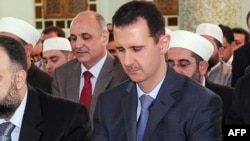 Syrian President Bashar al-Assad performs the morning Eid al-Fitr prayer at a mosque in Damascus in late August.