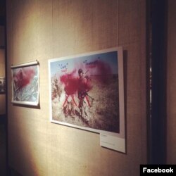 Photos at the exhibition in Moscow were doused with red paint.