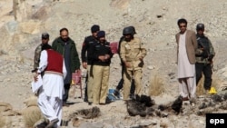 Pakistani security officials inspect the site of a bomb blast that targeted a vehicle of the Frontier Corps on January 2.