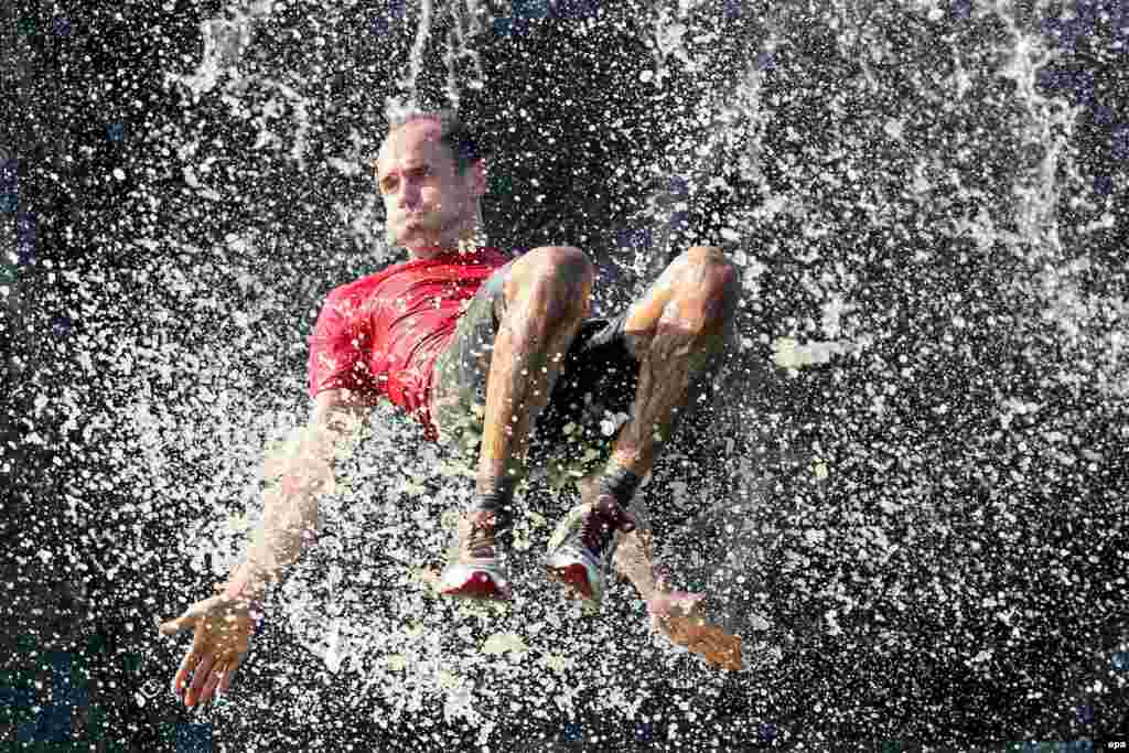 A participant makes a splash during the "Cross De Luxe" run at Markkleeberger, near Leipzig, Germany. (epa/Jan Woitas)