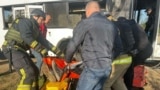 Ukrainian rescuers evacuate a wounded person from a bus damaged by a Russian drone strike in the town of Marhanets, in the Dnipropetrovsk region, on April 23.