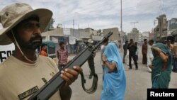 A paramilitary soldier stands guard after a gunfight in Karachi on June 2.