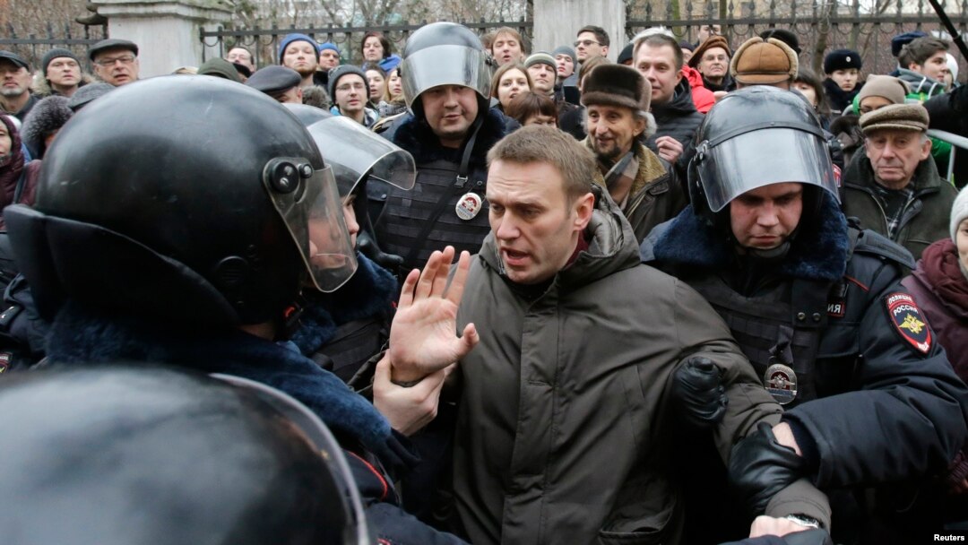 Russian police detain opposition leader Aleksei Navalny outside a courthouse in Moscow on February 24.