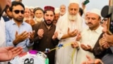 Manzoor Pashteen (center), the leader of the Pashtun Tahafuz Movement, is inaugurated at a jirga , or assembly, on September 29.