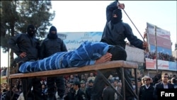 A public flogging of a prisoner in Iran. Undated.