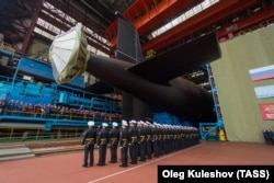 Members of the Russian Navy attend the launch of the 885M Yasen-M nuclear submarine K-571 Krasnoyarsk at the Sevmash shipyard in Severodvinsk in July 2021.