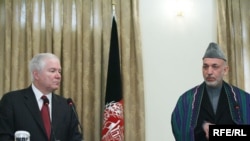 U.S. Defense Secretary Robert Gates speaks alongside Hamid Karzai on December 8.