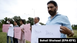 Members of the media hold up placards during a protest against the abduction and mistreatment of journalists, in Islamabad on July 22, 2020.