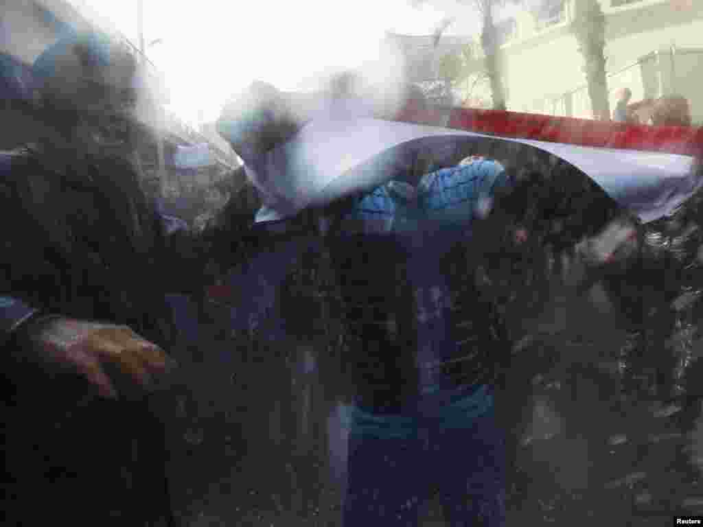 Demonstrators brave police water cannons and tear gas during a protest in Cairo on January 28.