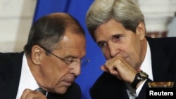 U.S. Secretary of State John Kerry (right) and Russian Foreign Minister Sergei Lavrov confer during a press briefing at the State Department in Washington on August 9.