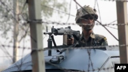 An Indian soldier patrols on the India-Pakistan border. 