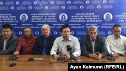 Zhanbolat Mamai (center) and other members of the Democratic Party of Kazakhstan talk to reporters in Almaty on February 19. 