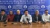 Zhanbolat Mamai (center) and other members of the Democratic Party of Kazakhstan talk to reporters in Almaty on February 19. 