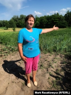 Lyudmyla Borkinets points to a field that she cultivates in the village of Hryshchyntsi in central Ukraine.