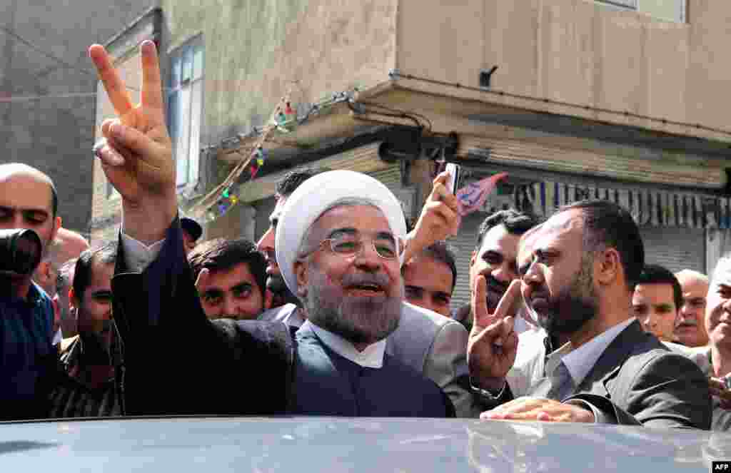 Rohani flashed a victory sign as he left a polling station after casting his ballot in Tehran.