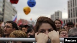 Opposition supporters stand in front of the stage during the "March of Millions" protest rally in Moscow on September 15.