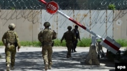 Australian Force members walk through the Green Zone in Kabul.