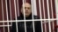 Fashion designer Sasha Varlamau attends the opening court hearing during his trial in Minsk on February 4.