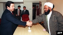 Turkmen Foreign Minister Boris Shikhmuradov (left) shakes hand with a senior Afghan Taliban official during a meeting in Islamabad in 1999.