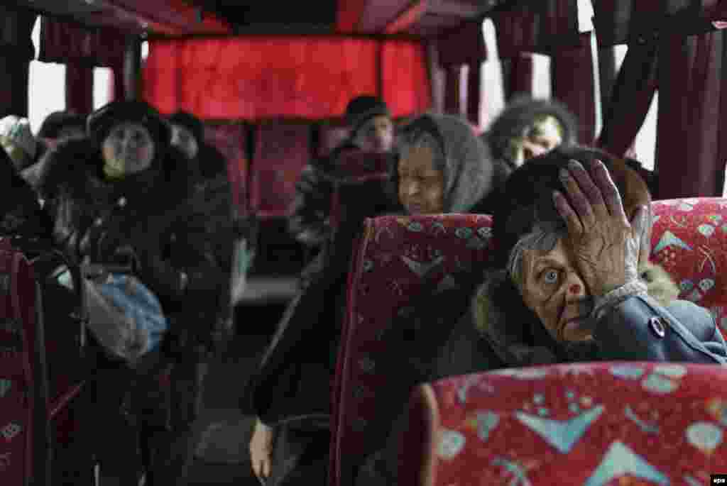 Local citizens sit in a bus as they wait to be evacuated from the besieged city of Debaltseve in Ukraine's eastern Donetsk region on February 3. (epa/Anastasia Vlasova)