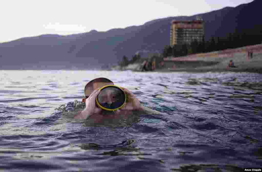 Vladimir Salangin swims near Gagra beach. The 21-year-old works as a security guard in southern Russia and saw the sea for the first time the day before this picture was taken. The cheap resort town of Gagra is hugely popular with working-class Russians.