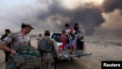 Displaced people seek refuge while fleeing from clashes during an operation to attack Islamic State militants in Mosul on October 19. 