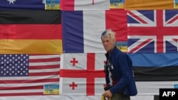 A photo from Kyiv's Independence Square in Kyiv in 2022 shows Ryan Wesley Routh sticking up national flags of the countries helping Ukraine.