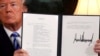 U.S. President Donald Trump holds up a proclamation declaring his intention to withdraw from the Iran nuclear agreement after signing it in the Diplomatic Room at the White House in Washington on May 8.