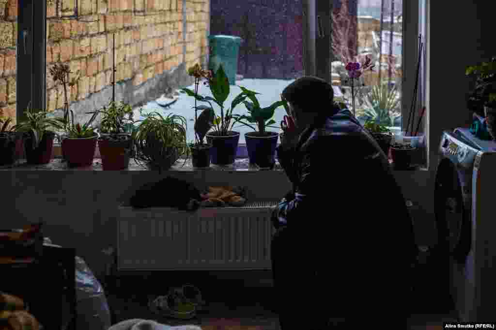 Bekir smokes at the window at a relative’s home in Crimea. His son Mustafa was held at a remand center in Simferopol for two years on charges of “participating in mass riots.” Mustafa is now under house arrest. 
