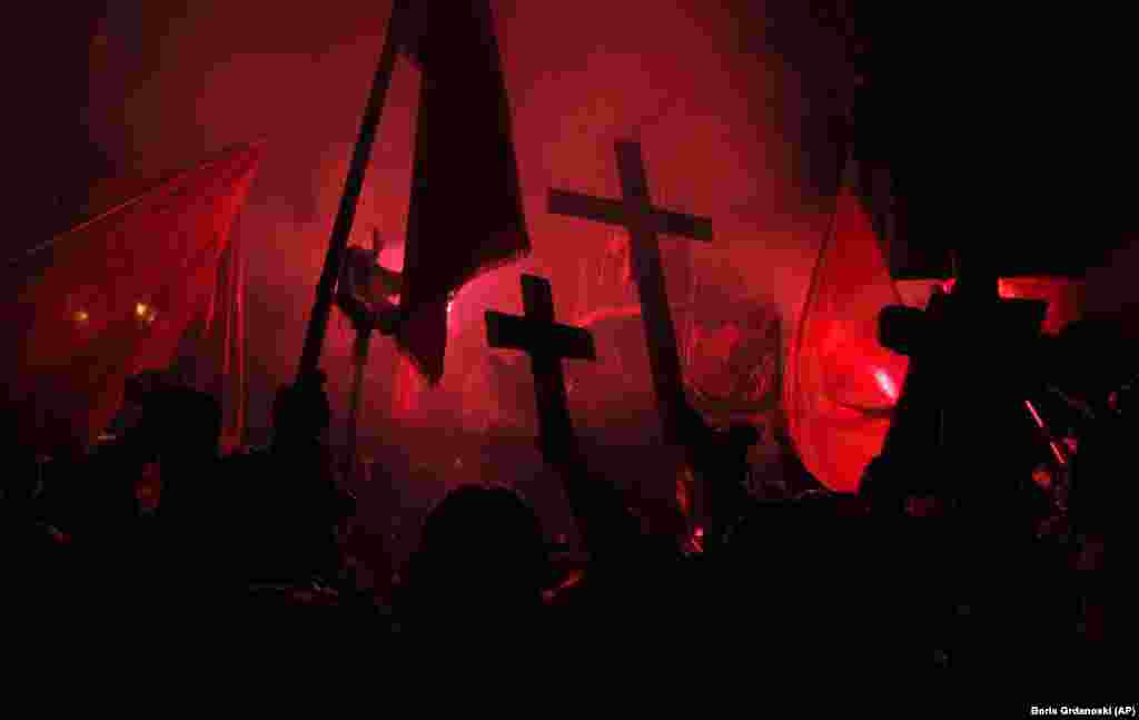 Protesters carry crosses and torches during a rally against plans to change Macedonia&#39;s constitutional name in Skopje on February 27. Several thousand protesters gathered in front of the former Yugoslav republic&#39;s parliament to demand that the government call off talks with neighbor Greece on a decades-long name dispute. (AP/Boris Grdanoski)