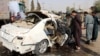 Afghan security officials inspect the scene of a IED blast in Helmand on November 12, 2020, that killed Radio Free Afghanistan journalist Mohammad Ilyas Dayee. 