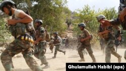 Afghan soldiers take positions in restive Achin district in the eastern Nangarhar province on August 18. Afghan and U.S. forces are engaged in an operation against the Islamic State militants in August.