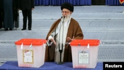 Iranian Supreme Leader Ayatollah Ali Khamenei gestures as he casts his vote during the presidential election in Tehran on May 19.