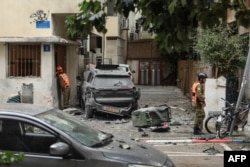 First responders work at the site of a strike in a residential neighborhood of Tel Aviv on April 1.