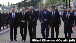 RUSSIA -- Participants walk along an embankment after a Supreme Eurasian Economic Council meeting in Sochi, May 14, 2018