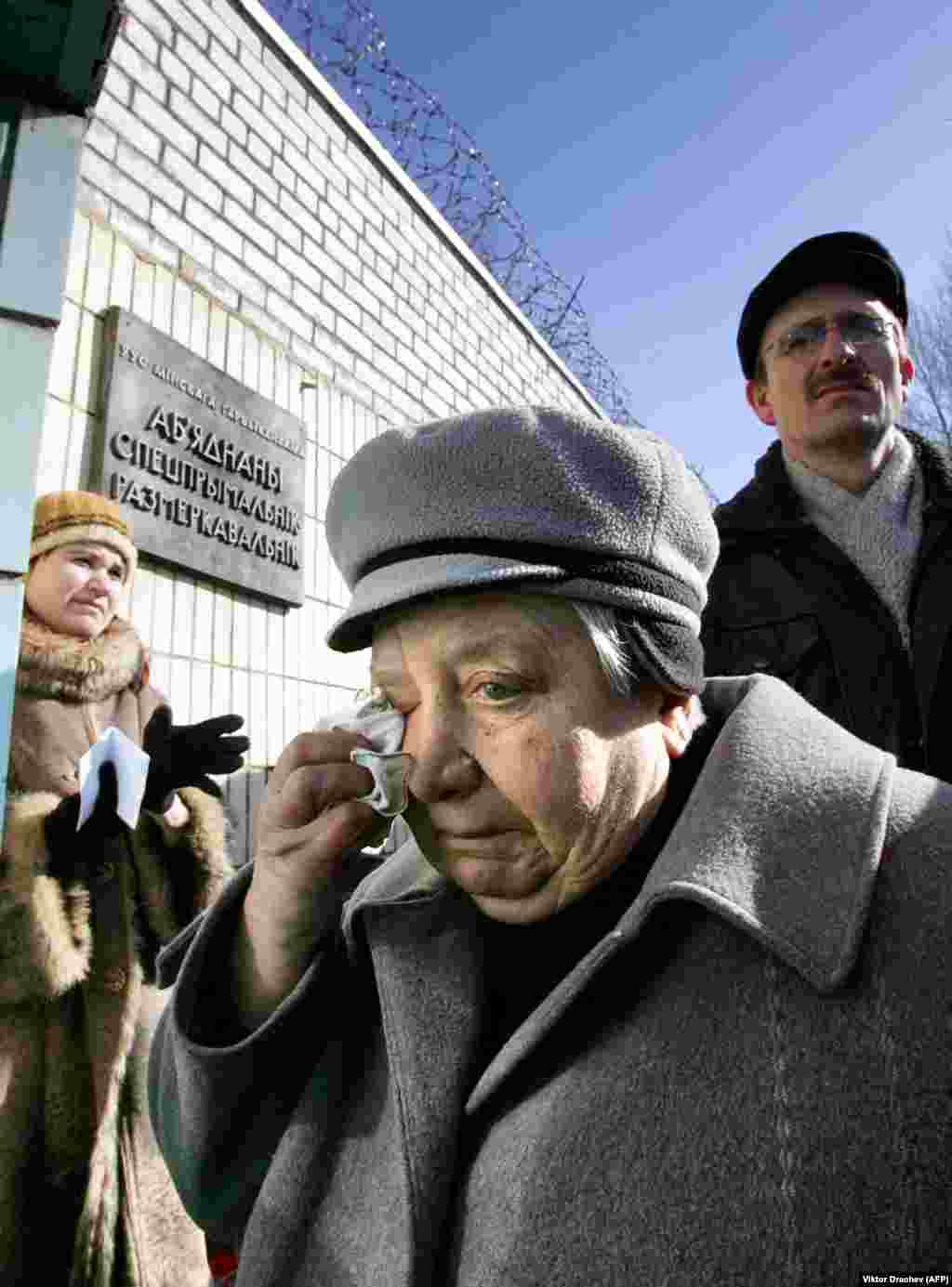 A relative of an antigovernment supporter who had been detained in Minsk dabs away a tear as she waits for news outside a police station.