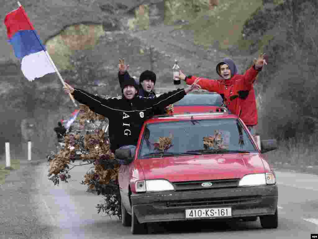 Kosovo Serbs in the town of Gracanica wave Serbian flags and carry oak branches, a traditional Christmas symbol.