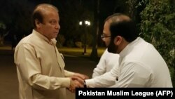 Jailed former Pakistani Prime Minister Nawaz Sharif greets supporters after being released temporarily on parole in Lahore on September 12