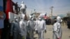 Volunteers in protective suits disinfect public areas in the capital Kabul to help in curbing the spread of the coronavirus infections on April 8.
