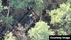 Bruce and another fighter with a Russian flag after capturing a position near Lyman in the Donetsk region of Ukraine