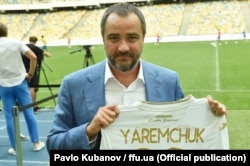 Ukrainian Football Federation President Andriy Pavelko shows off the new uniform, which features the slogan "Glory to Ukraine!" The new uniform debuted two months after FIFA fined a Croatian coach and warned a player over a video featuring the slogan.