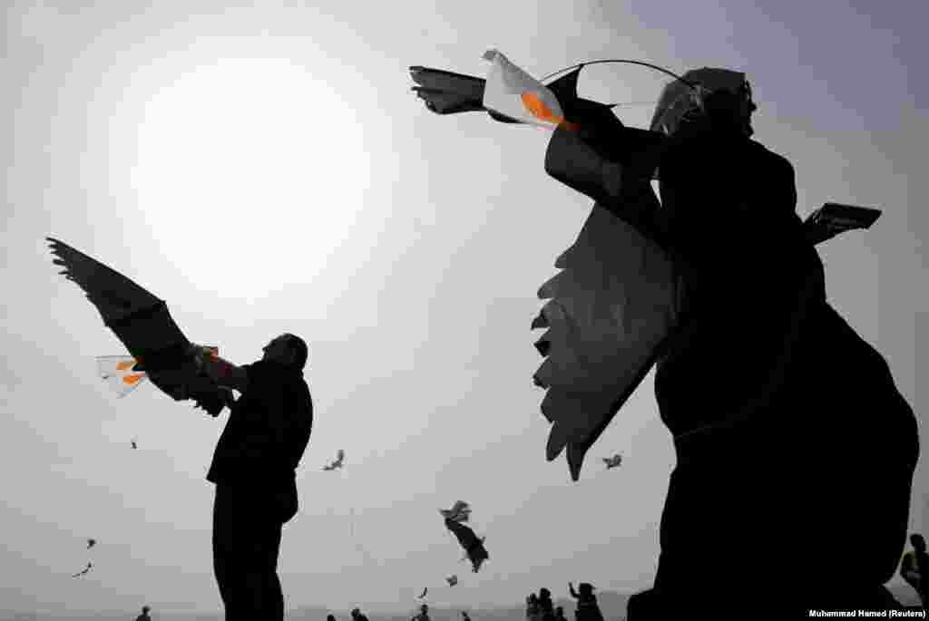 People prepare to fly kites to mark World Migratory Bird Day in the city of Aqaba, Jordan, on April 4. (Reuters/Muhammad Hamed)