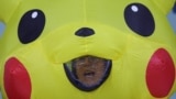 A demonstrator in a Pikachu costume reacts as global environmental activists protest against the gas industry during the United Nations Climate Change Conference (COP29) in Baku.