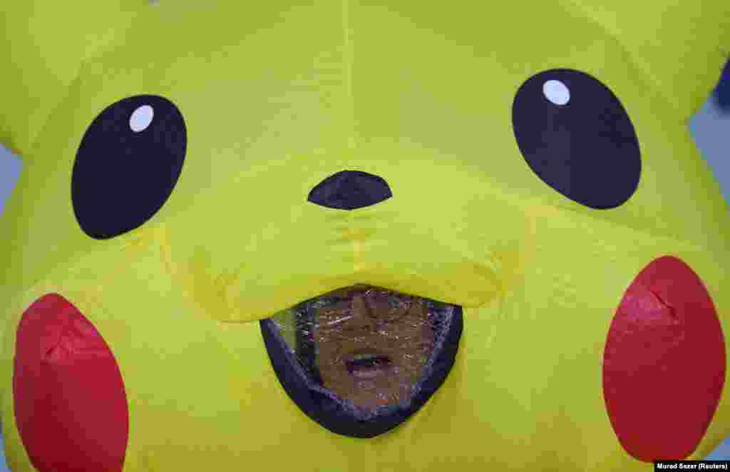 A demonstrator in a Pikachu costume reacts as global environmental activists protest against the gas industry during the United Nations Climate Change Conference (COP29) in Baku.