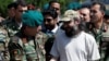 Ali Haider Gilani, (R) son of former Pakistani prime minister Yusuf Raza Gilani, shakes hands with Afghan Joint Chief of Staff Gen. Qadamshah Shahim after he was rescued in Afghanistan in a joint operation by Afghan and U.S. forces on May 10.